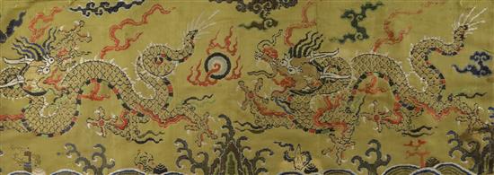 A Chinese yellow brocade dragon panel fragment, 17th century, 64.5 x 25cm